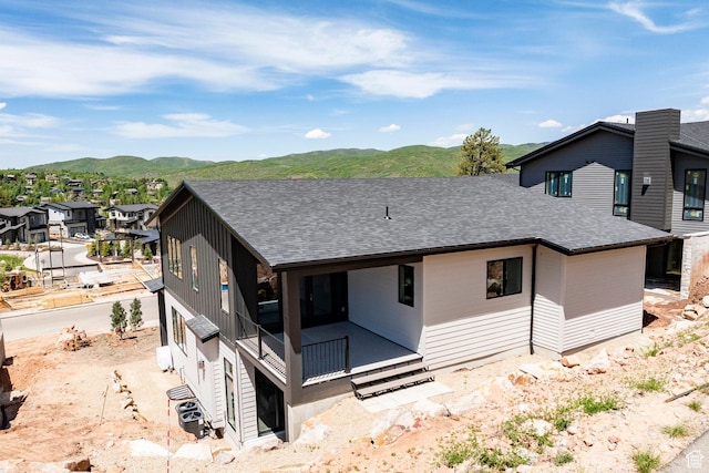 4107 W Crest Ct, Park City, UT 84098 - rear view of house with a shingled roof, a mountain view, and a residential view