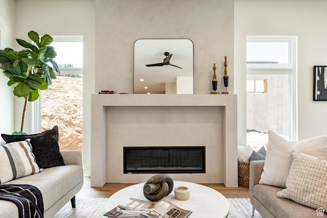 4107 W Crest Ct, Park City, UT 84098 - living room featuring a glass covered fireplace, wood finished floors, plenty of natural light, and a ceiling fan