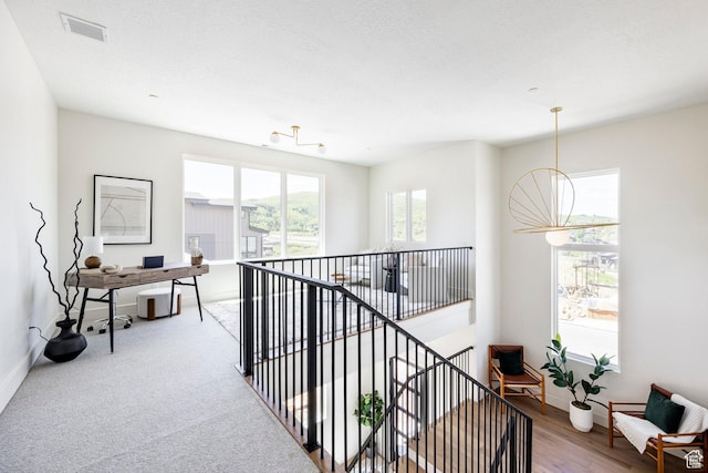 4107 W Crest Ct, Park City, UT 84098 - corridor with an office area, an upstairs landing, baseboards, and a chandelier