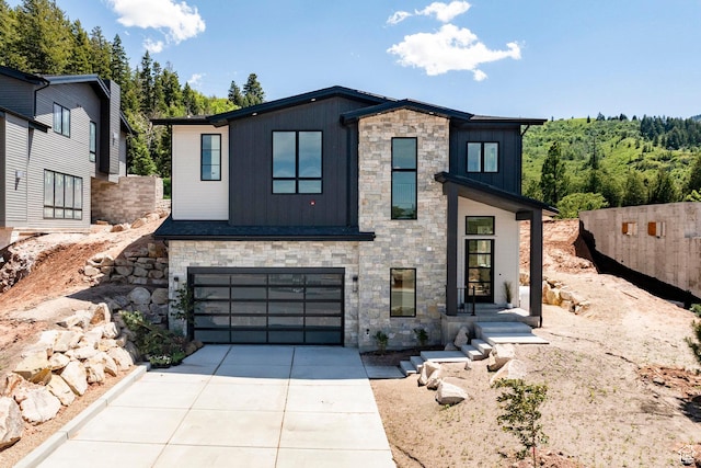 4107 W Crest Ct, Park City, UT 84098 - contemporary home featuring stone siding, concrete driveway, board and batten siding, and a garage