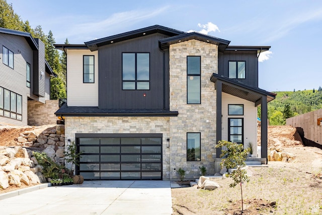4107 W Crest Ct, Park City, UT 84098 - contemporary home with stone siding, driveway, and an attached garage
