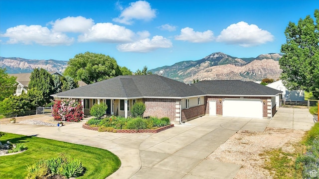 130 S 1500 W, Marriott Slaterville, UT 84404 - view of front of home with a mountain view, driveway, an attached garage, and brick siding