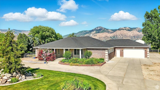 130 S 1500 W, Marriott Slaterville, UT 84404 - view of front of property with concrete driveway, a mountain view, a garage, and brick siding