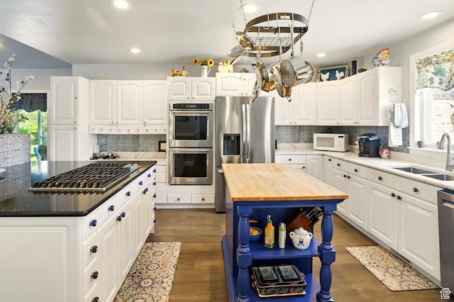 130 S 1500 W, Marriott Slaterville, UT 84404 - kitchen with stainless steel appliances, wooden counters, a sink, a center island, and plenty of natural light