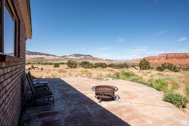 397 N Wendy Dr, Torrey, UT 84775 - view of patio / terrace with an outdoor fire pit and a mountain view