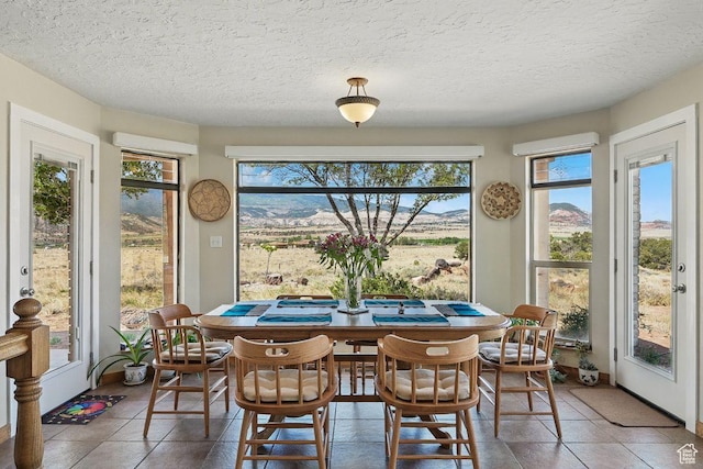 397 N Wendy Dr, Torrey, UT 84775 - tiled dining room with healthy amount of natural light and a textured ceiling