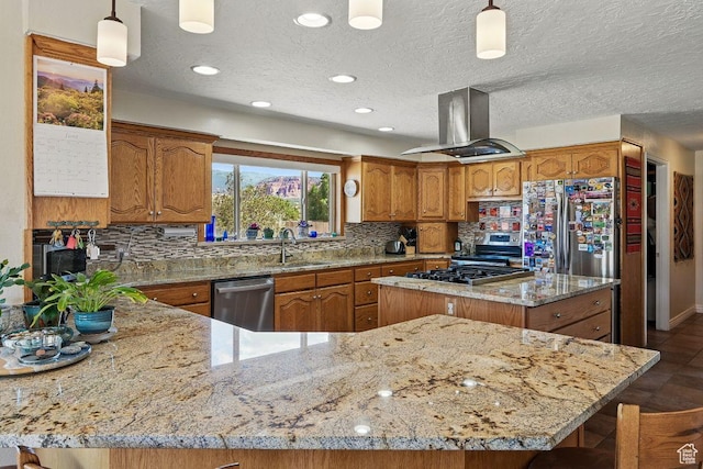 397 N Wendy Dr, Torrey, UT 84775 - kitchen featuring stainless steel appliances, island range hood, brown cabinets, light stone countertops, and a textured ceiling