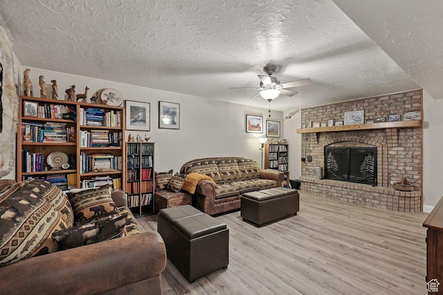 397 N Wendy Dr, Torrey, UT 84775 - living area with wood finished floors, a ceiling fan, a brick fireplace, and a textured ceiling