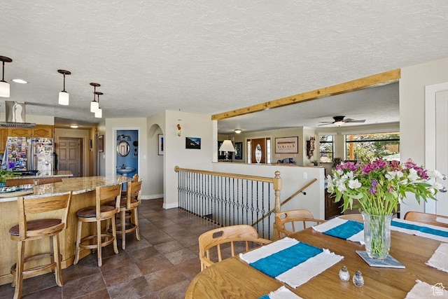 397 N Wendy Dr, Torrey, UT 84775 - dining space with baseboards, a ceiling fan, and a textured ceiling