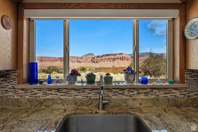 397 N Wendy Dr, Torrey, UT 84775 - kitchen view of a sink, decorative backsplash, a mountain backdrop, and stone countertops
