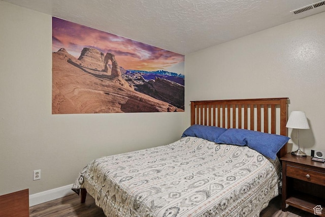397 N Wendy Dr, Torrey, UT 84775 - bedroom with wood finished floors, baseboards, and a textured ceiling