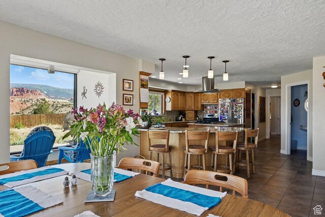 397 N Wendy Dr, Torrey, UT 84775 - dining space with dark tile patterned floors, a textured ceiling, and baseboards