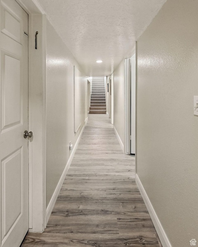 397 N Wendy Dr, Torrey, UT 84775 - corridor featuring baseboards, wood finished floors, a textured ceiling, and stairway