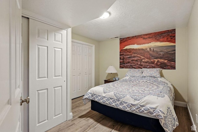 397 N Wendy Dr, Torrey, UT 84775 - bedroom featuring wood finished floors, a textured ceiling, a closet, and baseboards