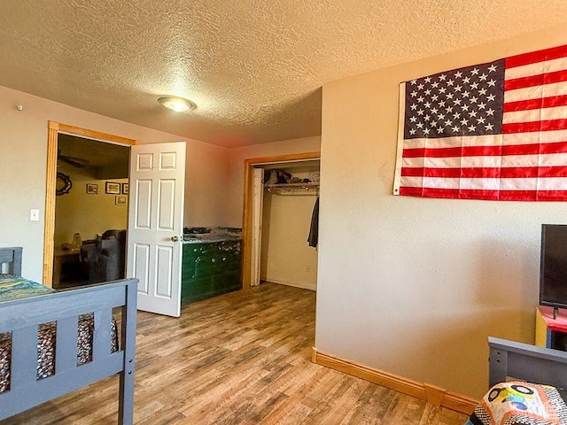 425 E Mule Deer Rd, Central, UT 84722 - bedroom with a textured ceiling, wood finished floors, and baseboards
