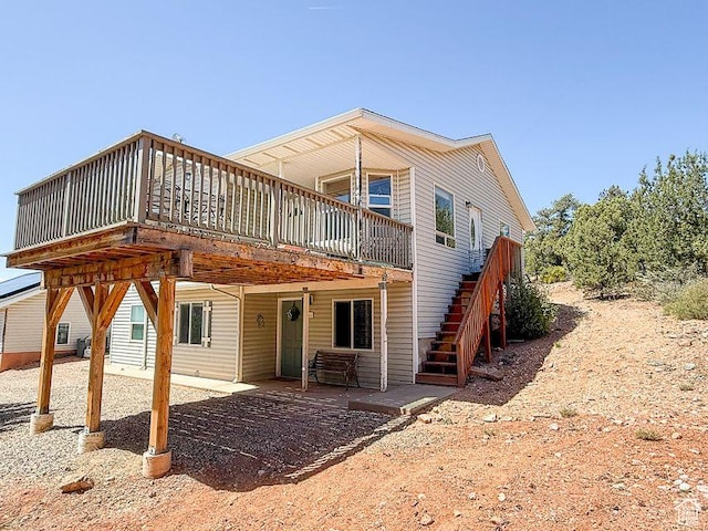 425 E Mule Deer Rd, Central, UT 84722 - back of property with a wooden deck, a patio, and stairs