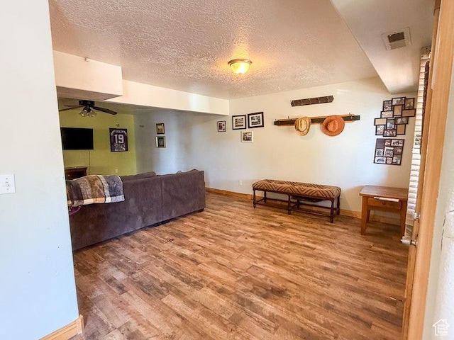 425 E Mule Deer Rd, Central, UT 84722 - living room with wood finished floors, ceiling fan, a textured ceiling, and baseboards