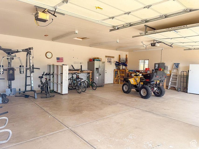 425 E Mule Deer Rd, Central, UT 84722 - garage featuring stainless steel fridge, a garage door opener, and freestanding refrigerator