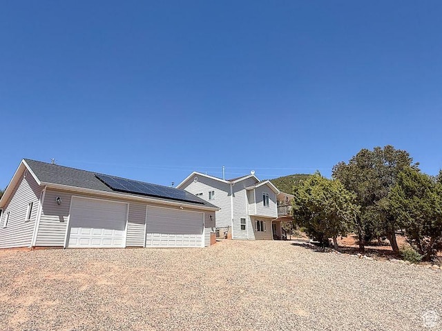 425 E Mule Deer Rd, Central, UT 84722 - view of front of property featuring roof mounted solar panels, a detached garage, and an outbuilding