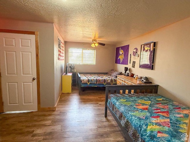 425 E Mule Deer Rd, Central, UT 84722 - bedroom featuring wood finished floors, a textured ceiling, and ceiling fan