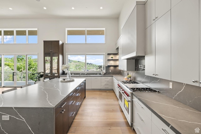 3654 Aspen Camp Loop, Park City, UT 84098 - kitchen featuring double oven range, wall chimney range hood, recessed lighting, light wood-style floors, and backsplash