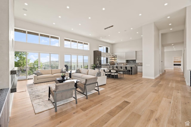 3654 Aspen Camp Loop, Park City, UT 84098 - living area featuring recessed lighting, a high ceiling, light wood-style flooring, and baseboards