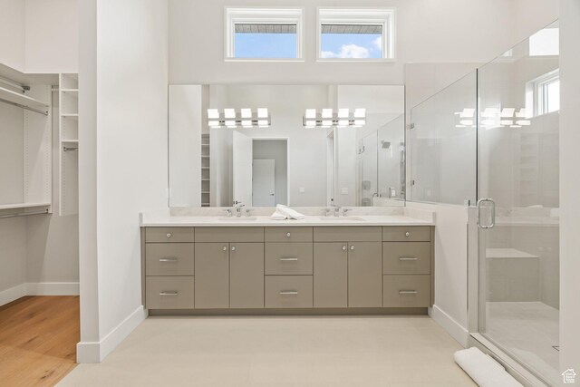 3654 Aspen Camp Loop, Park City, UT 84098 - full bathroom featuring double vanity, a stall shower, baseboards, and a spacious closet