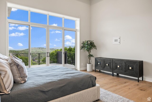 3654 Aspen Camp Loop, Park City, UT 84098 - bedroom with wood finished floors, multiple windows, baseboards, access to exterior, and a towering ceiling