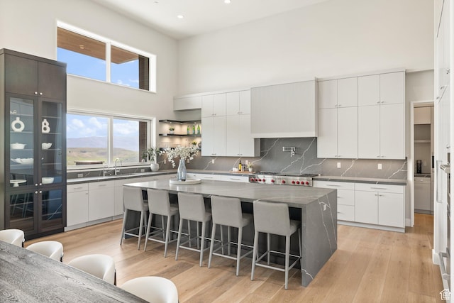 3654 Aspen Camp Loop, Park City, UT 84098 - kitchen featuring a breakfast bar area, decorative backsplash, a center island, recessed lighting, and white cabinets