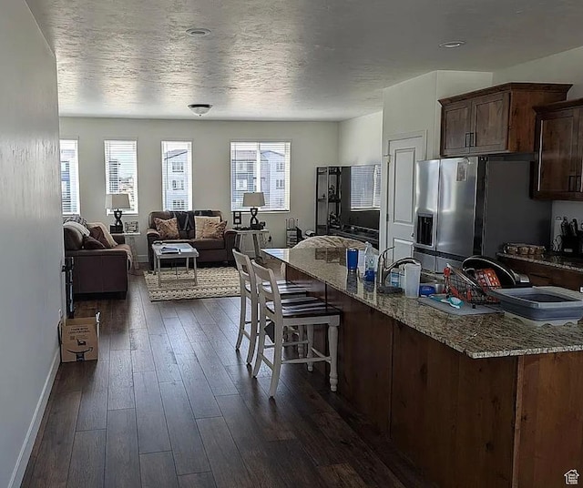 448 S 900 W, American Fork, UT 84003 - kitchen featuring stainless steel fridge with ice dispenser, plenty of natural light, baseboards, and a kitchen breakfast bar