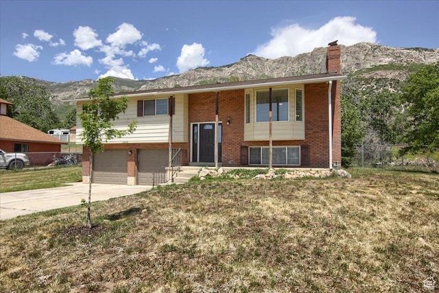 1272 E 2925 N, North Ogden, UT 84414 - bi-level home featuring brick siding, a mountain view, a garage, and a chimney