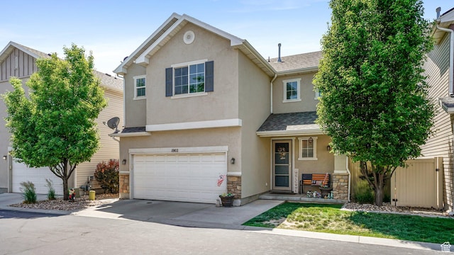 1002 W Stonehaven Dr Unit 108, North Salt Lake, UT 84054 - view of front facade featuring stone siding, stucco siding, a garage, driveway, and roof with shingles
