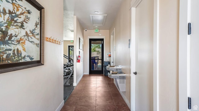 1002 W Stonehaven Dr Unit 108, North Salt Lake, UT 84054 - hall featuring attic access, baseboards, and dark tile patterned flooring