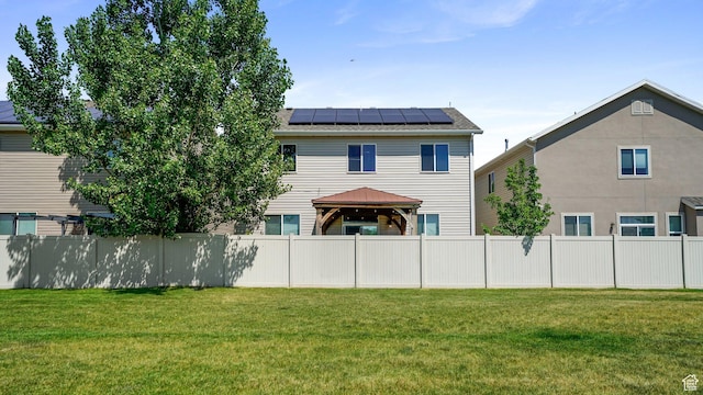 1002 W Stonehaven Dr Unit 108, North Salt Lake, UT 84054 - rear view of property featuring a gazebo and roof mounted solar panels