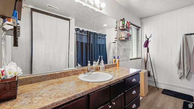1002 W Stonehaven Dr Unit 108, North Salt Lake, UT 84054 - full bathroom featuring vanity, wood finished floors, and a shower with curtain