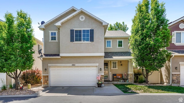 1002 W Stonehaven Dr Unit 108, North Salt Lake, UT 84054 - traditional-style home with stone siding, stucco siding, an attached garage, concrete driveway, and a shingled roof