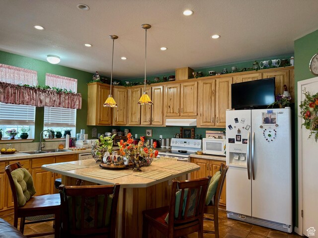 2780 S Bunch Grass Dr Unit 16, Garden City, UT 84028 - kitchen with white appliances, a sink, under cabinet range hood, recessed lighting, and tile counters