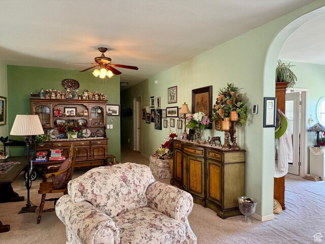2780 S Bunch Grass Dr Unit 16, Garden City, UT 84028 - carpeted living area featuring arched walkways and ceiling fan