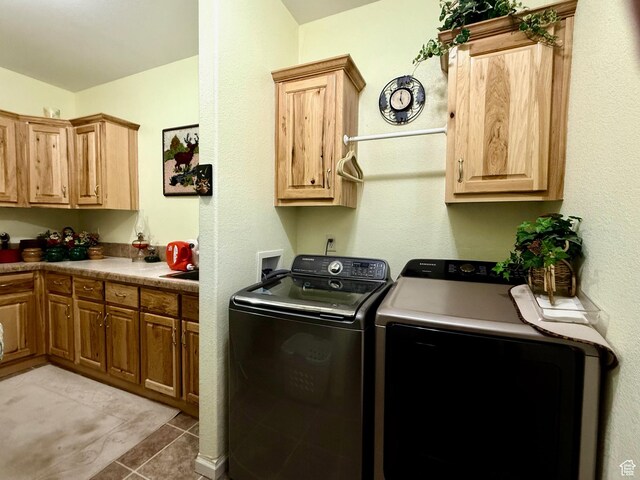 2780 S Bunch Grass Dr Unit 16, Garden City, UT 84028 - washroom featuring washer and dryer, cabinet space, and light tile patterned floors
