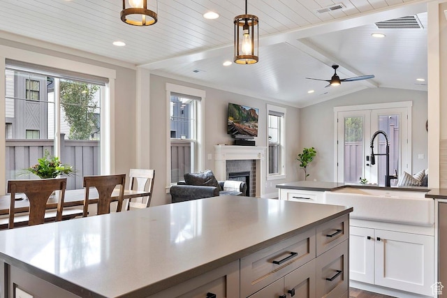 1494 W Lincoln Way, Kaysville, UT 84037 - kitchen with a kitchen island, a sink, a brick fireplace, decorative light fixtures, and a ceiling fan