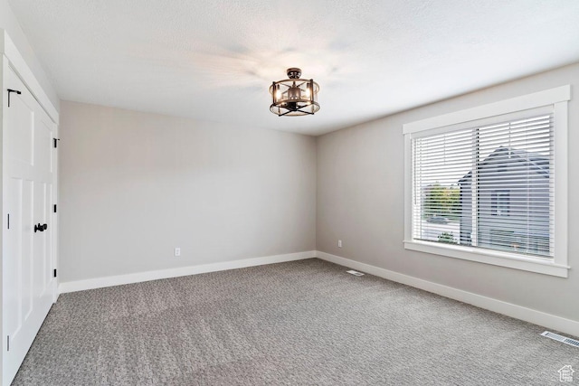 1494 W Lincoln Way, Kaysville, UT 84037 - carpeted empty room featuring baseboards and a chandelier