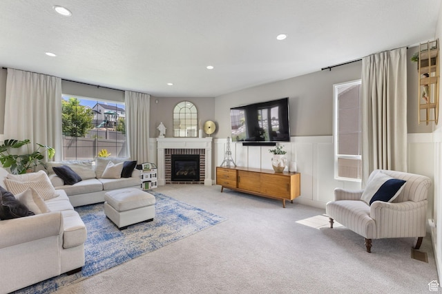 776 W Horizon Dr, Lehi, UT 84043 - carpeted living area with recessed lighting, a wainscoted wall, a brick fireplace, and a decorative wall