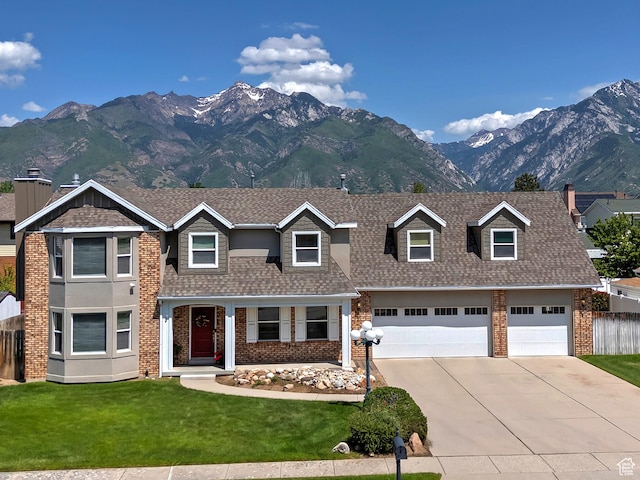 9039 S 1660 E, Sandy, UT 84093 - view of front of property featuring a mountain view, concrete driveway, brick siding, and a shingled roof