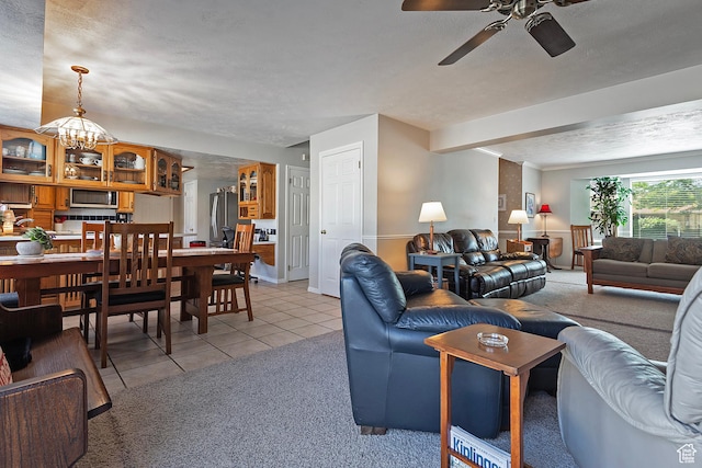 9039 S 1660 E, Sandy, UT 84093 - living room with ceiling fan, light tile patterned floors, light carpet, and a chandelier