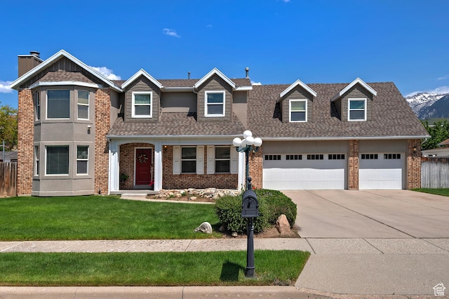 9039 S 1660 E, Sandy, UT 84093 - view of front of house featuring concrete driveway, brick siding, an attached garage, and roof with shingles