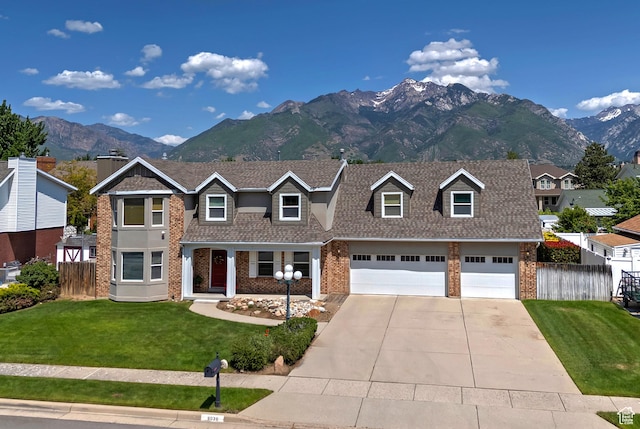 9039 S 1660 E, Sandy, UT 84093 - view of front facade featuring brick siding, concrete driveway, a mountain view, and a shingled roof