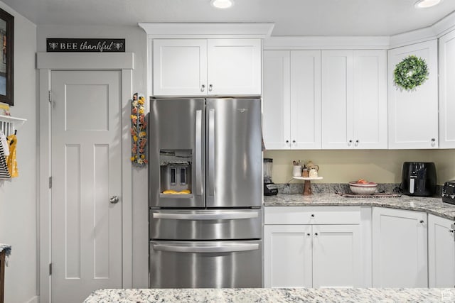 177 E 610 S, Santaquin, UT 84655 - kitchen featuring stainless steel fridge with ice dispenser, white cabinets, and light stone counters
