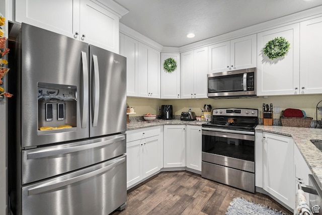 177 E 610 S, Santaquin, UT 84655 - kitchen featuring stainless steel appliances, dark wood-style flooring, white cabinets, recessed lighting, and light stone counters