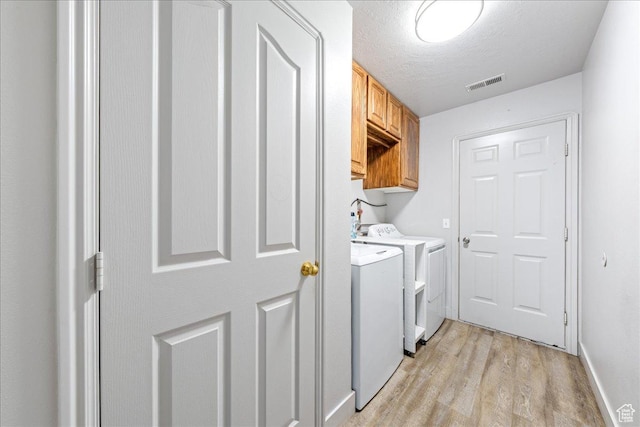 2811 E Paradise Way, St George, UT 84790 - washroom featuring washer and clothes dryer, cabinet space, light wood-style flooring, and a textured ceiling