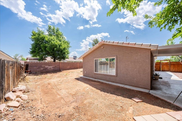 2811 E Paradise Way, St George, UT 84790 - view of side of home featuring a fenced backyard, stucco siding, and a patio area